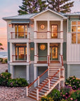 Front Exterior at Sunset — Haddie's Hideaway 2700R | 2,797 Sq Ft Reverse-Living Coastal House Plan | 3-4 Bed 4 Bath | Intertwine House Plans
