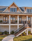 Front exterior view of Islabella, a 2,805 sq ft elevated coastal house plan with a covered front porch, X-pattern railings, a metal roof, a stair down to the front walk and a driveway along the side to the garage.
